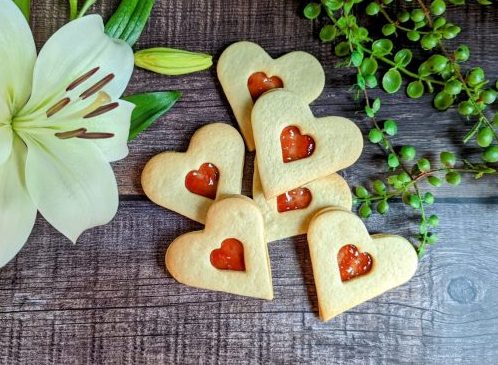 Sweet heart-shaped jam biscuits - a delicious treat for Valentine's Day or any other special occasion.